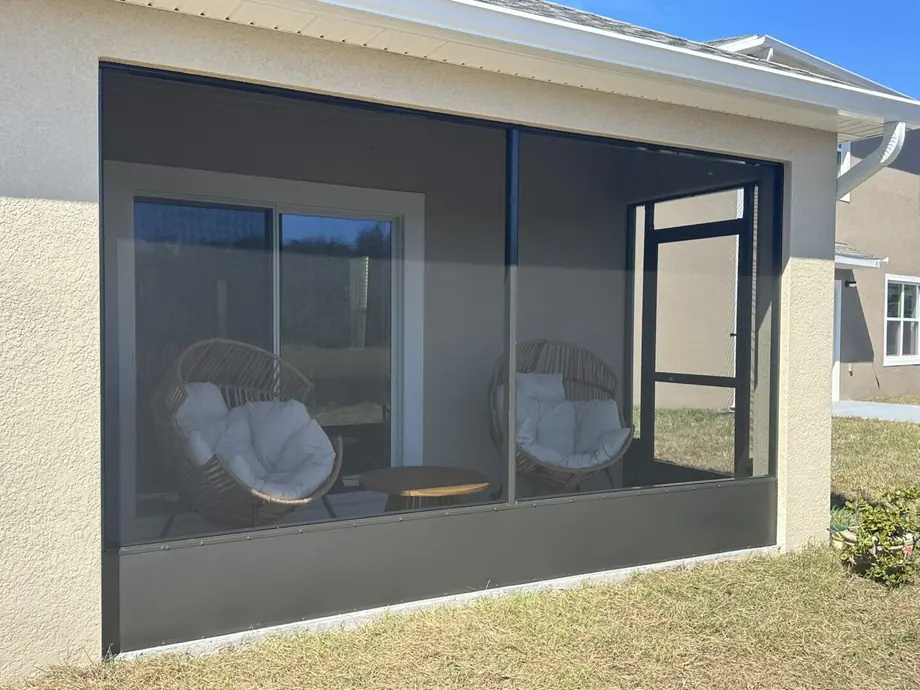 Screened outdoor living space attached to the back of a Florida home